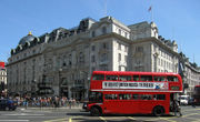 A red Routemaster bus crosses Piccadilly Circus